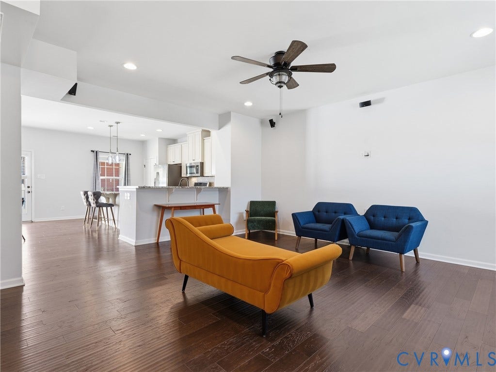 5612 Riverside Heights Way, Richmond, VA 23225 Open-concept living room with hardwood floors, recessed lighting, and a seamless connection to the kitchen.