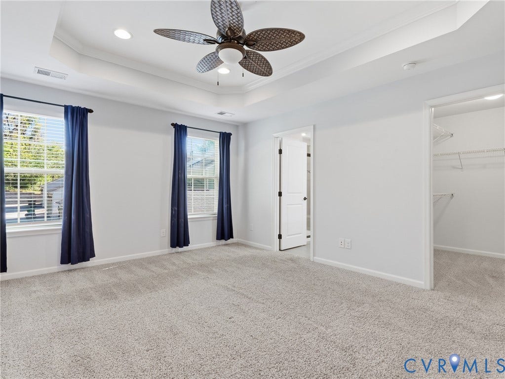 5612 Riverside Heights Way, Richmond, VA 23225 Generously sized primary suite with plush carpeting, walk-in closet, and private ensuite