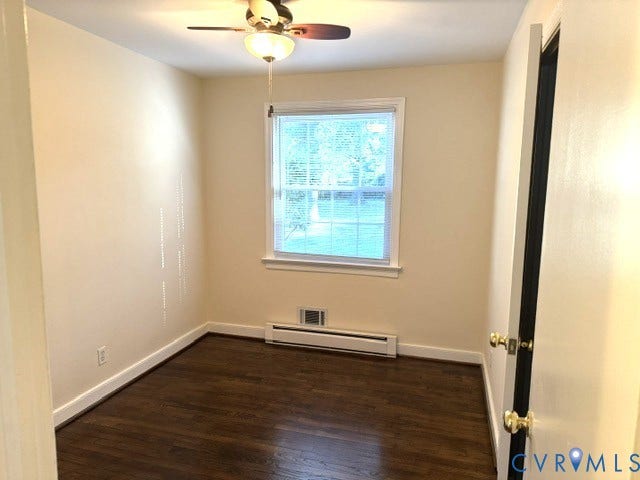 Hardwood flooring, single window, ceiling fan with integrated lighting, and a baseboard heater
