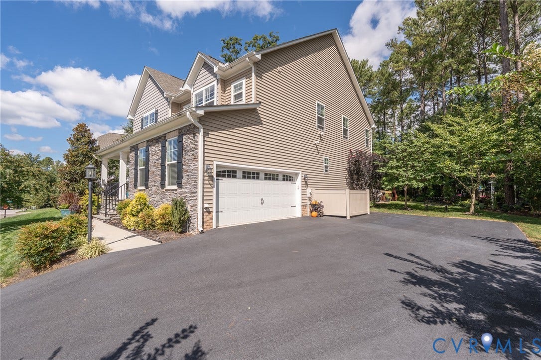 15412 Greenley Place, Hartridge At Harper's Mill, Chesterfield, VA 23832 The driveway has been extended 17' beyond the garage to create a larger parking pad.