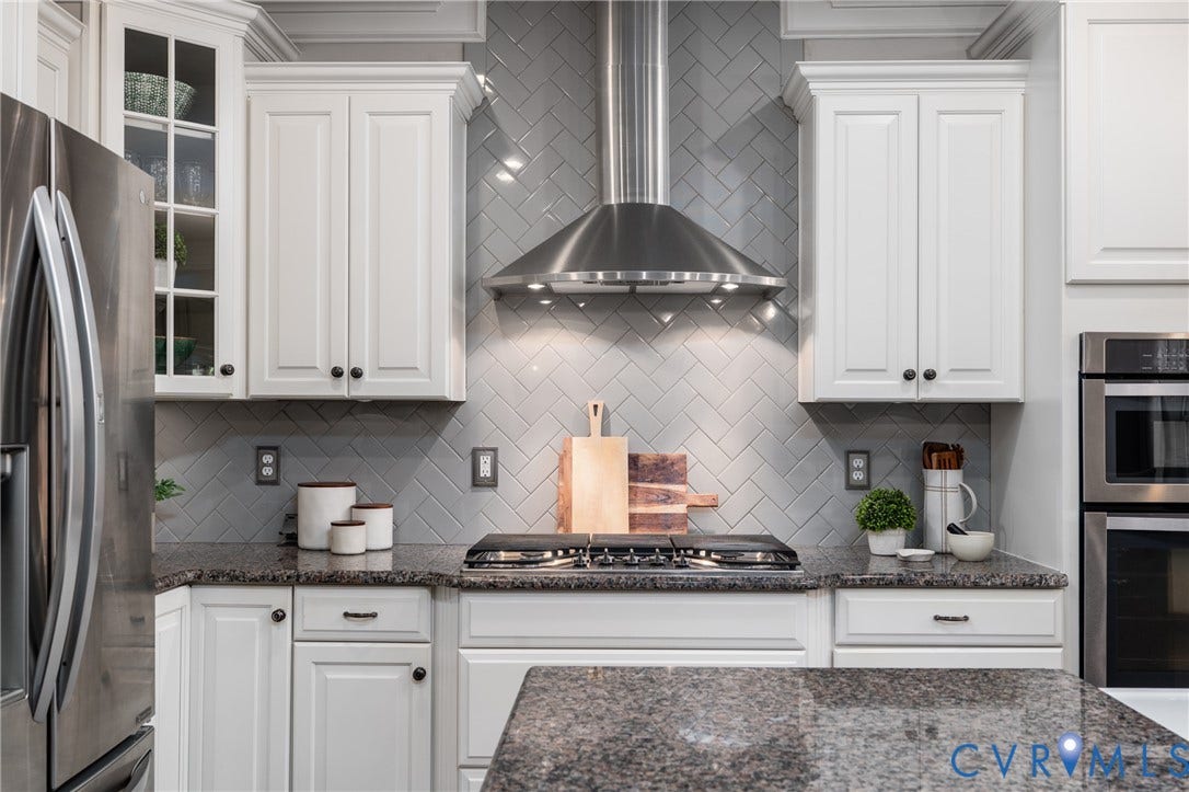 15412 Greenley Place, Hartridge At Harper's Mill, Chesterfield, VA 23832 Designer tile backsplash, generous cabinetry, and polished finishes distinguish this beautifully appointed kitchen.