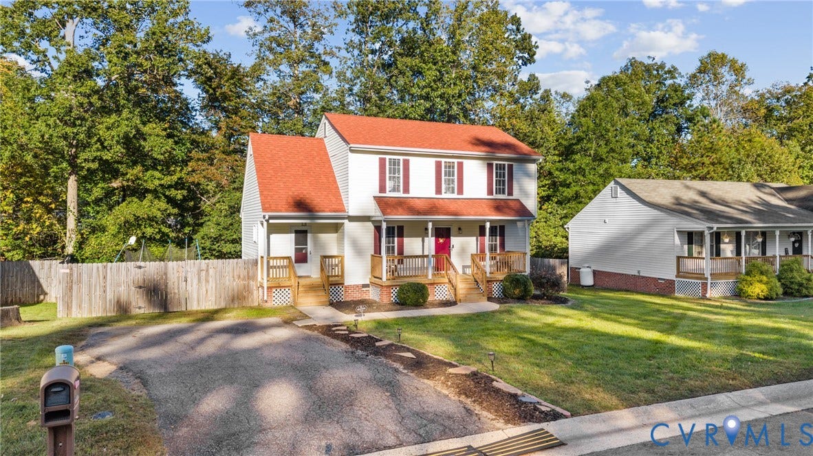 11512 Wiltstaff Drive, Midlothian, VA 23112 Two-story home with a red roof, light-colored siding, shuttered windows, a wood-framed covered front porch, and a paved driveway