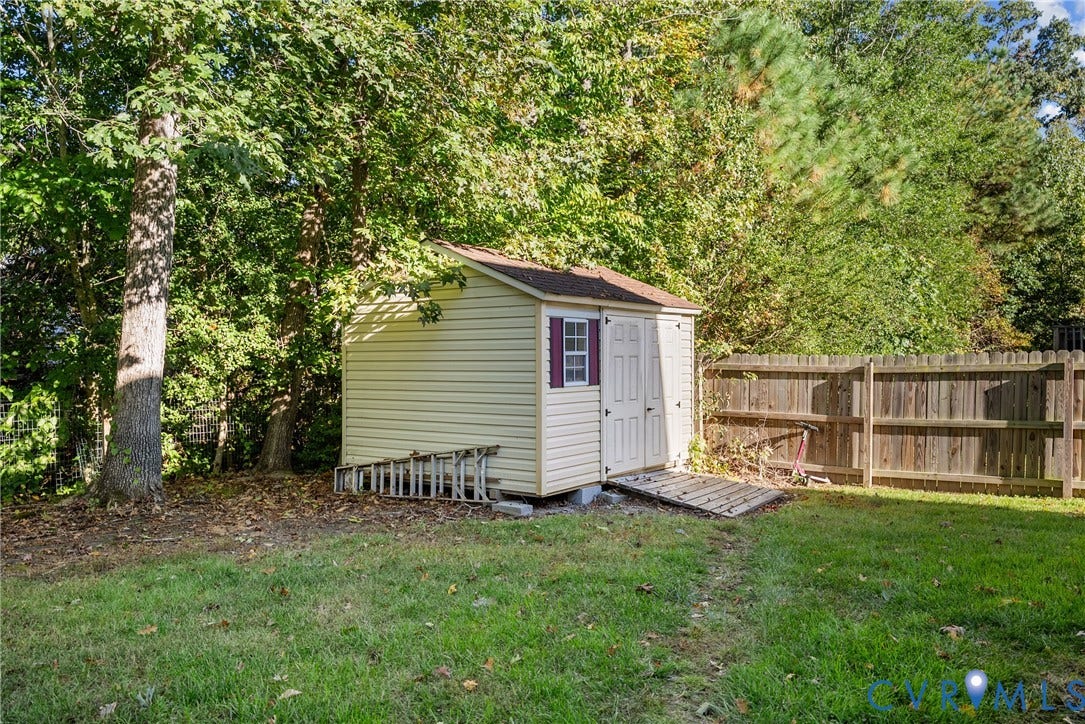 11512 Wiltstaff Drive, Midlothian, VA 23112 Backyard storage shed featuring vinyl siding, a single window, double-door entry with a ramp, and wood fencing
