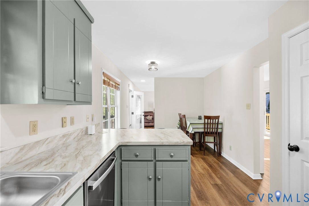 11512 Wiltstaff Drive, Midlothian, VA 23112 Kitchen featuring shaker-style cabinetry, stone-patterned laminate countertops, stainless steel sink, and wood-finish flooring
