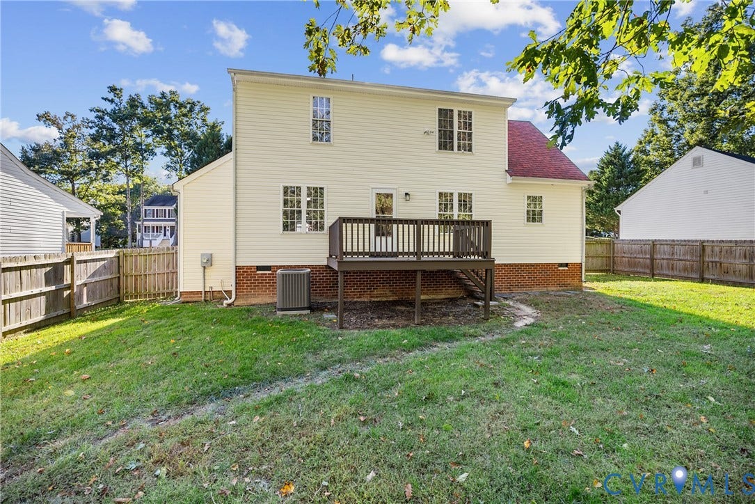 11512 Wiltstaff Drive, Midlothian, VA 23112 Rear exterior featuring a tiered deck, horizontal vinyl siding, brick foundation, and enclosed wood fencing