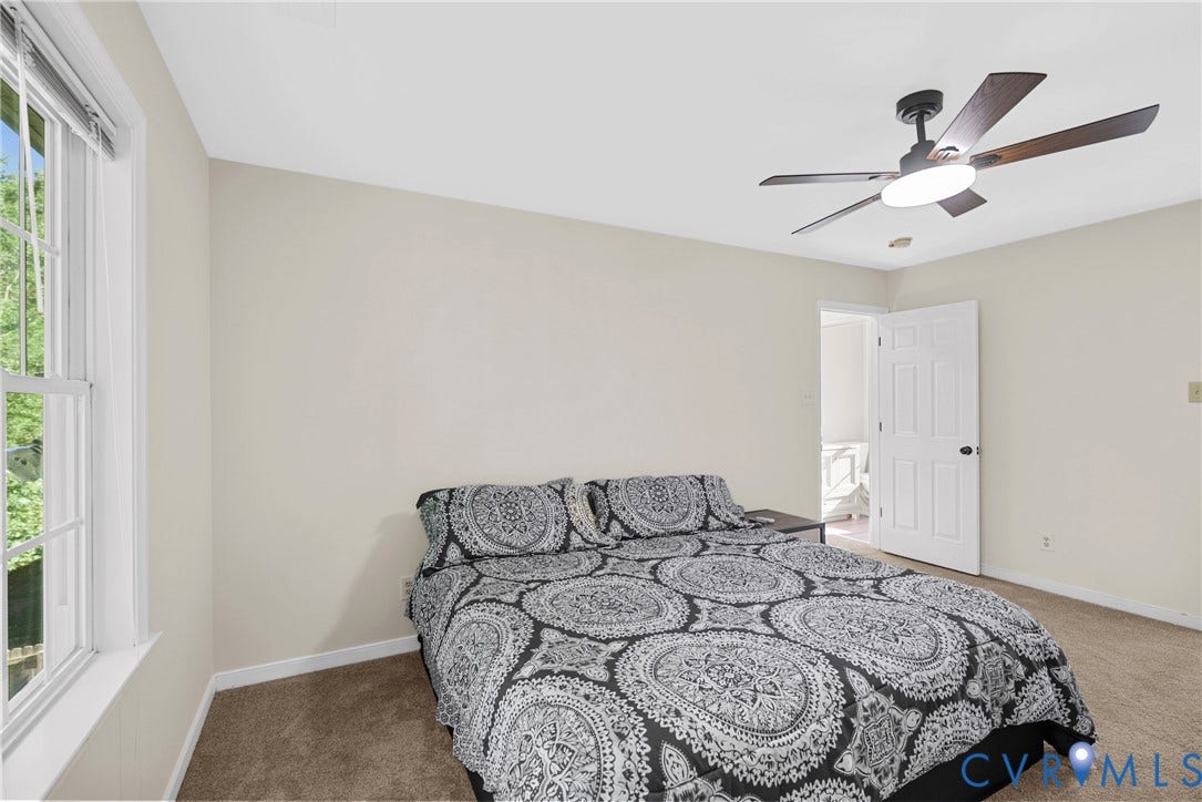 11512 Wiltstaff Drive, Midlothian, VA 23112 Neutral-toned walls, carpeted flooring, multi-pane window, and a ceiling-mounted light fixture with a fan