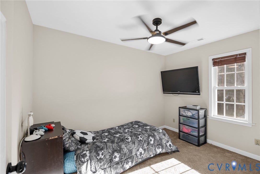 11512 Wiltstaff Drive, Midlothian, VA 23112 Neutral-toned interior room featuring wall-to-wall carpeting, a multi-pane window with wood-finish blinds, and a ceiling-mounted light fixture with a fan