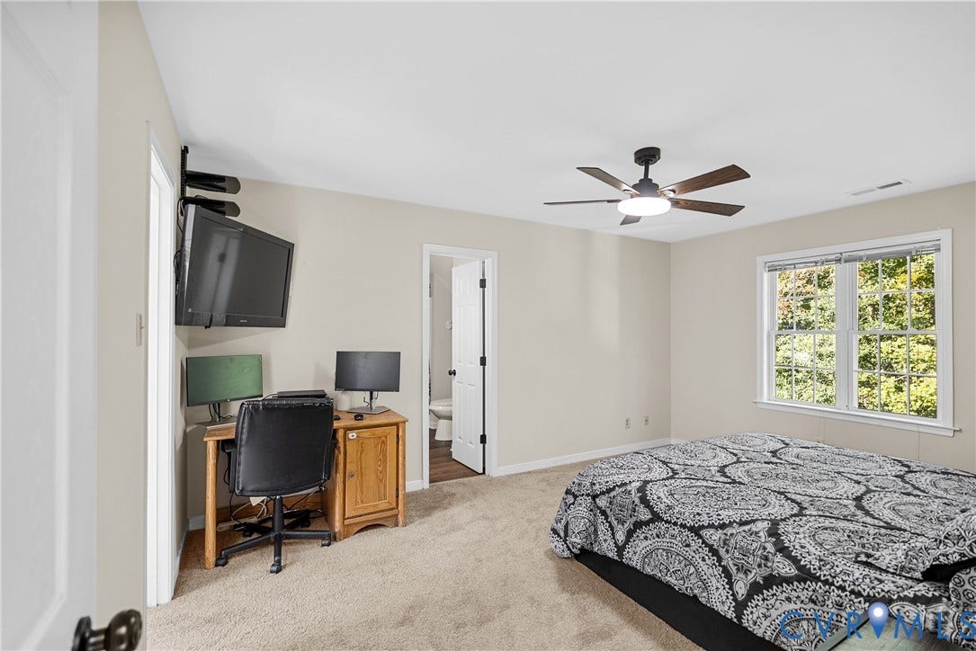 11512 Wiltstaff Drive, Midlothian, VA 23112 Neutral-toned interior featuring wall-to-wall carpeting, a multi-blade ceiling fan with integrated lighting, and a double-hung window