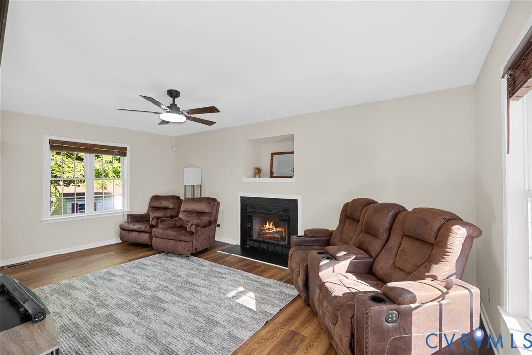 11512 Wiltstaff Drive, Midlothian, VA 23112 Wood-finish flooring, fireplace with a black surround, recessed wall niche, and ceiling fan with integrated lighting