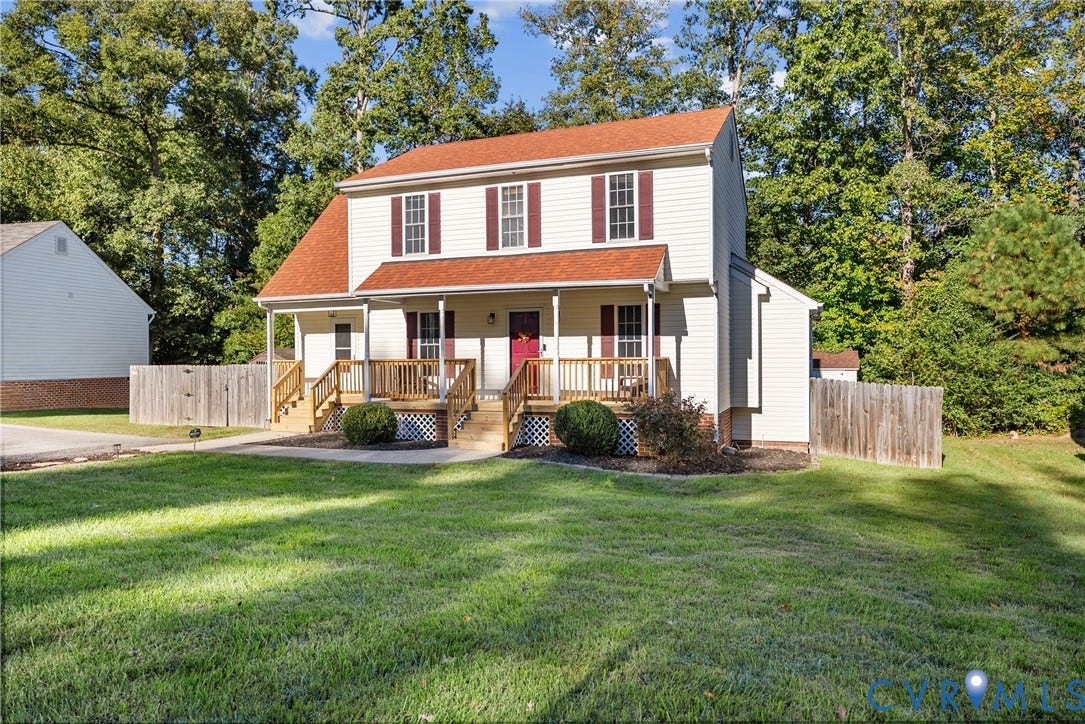 11512 Wiltstaff Drive, Midlothian, VA 23112 Two-story colonial residence featuring light-toned siding, dark shutters, a covered front porch, wooden deck railing, and a shingled roof