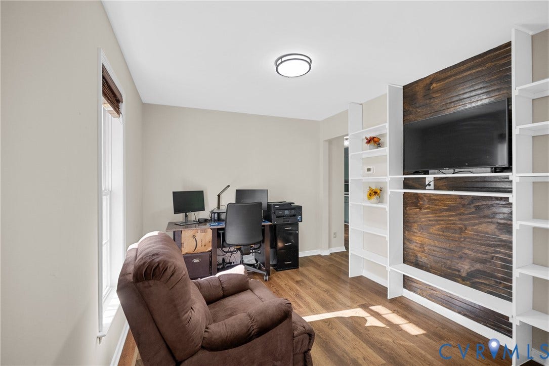 11512 Wiltstaff Drive, Midlothian, VA 23112 Built-in shelving units with a wood-plank accent wall, wood-finish flooring, and flush-mount ceiling lighting