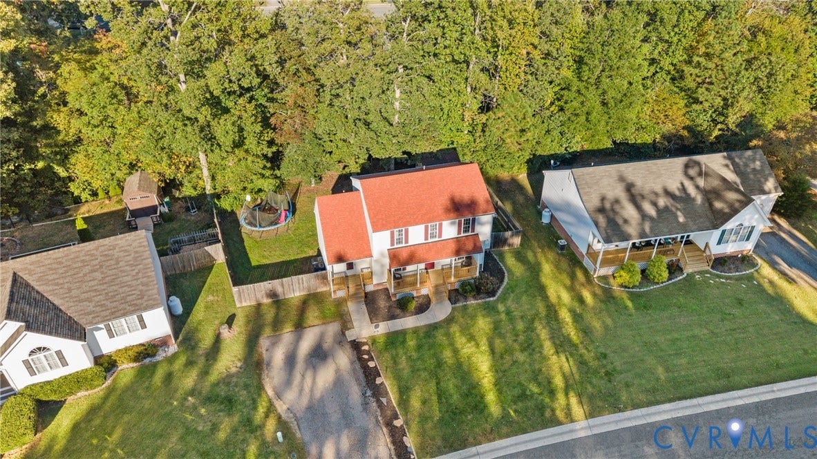 11512 Wiltstaff Drive, Midlothian, VA 23112 Two-story residence featuring a red shingled roof, front porch, concrete walkway, and a private rear yard with mature trees