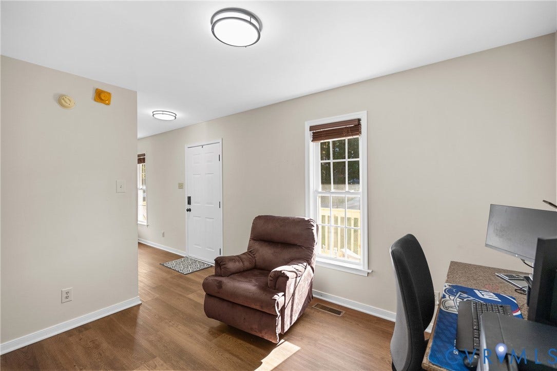 11512 Wiltstaff Drive, Midlothian, VA 23112 Neutral walls, wood-finish flooring, white paneled entry door, double-hung window with muntins, and flush-mount circular lighting fixtures