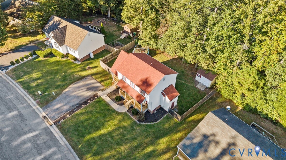 11512 Wiltstaff Drive, Midlothian, VA 23112 Aerial perspective of a two-story residence featuring a shingled roof, paved driveway, rear wood-fencing, and mature perimeter trees