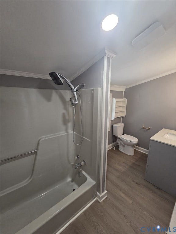 Off the Kicthen. Bathroom featuring a shower/tub combination, detachable showerhead, wood-finish flooring, and a single-sink vanity