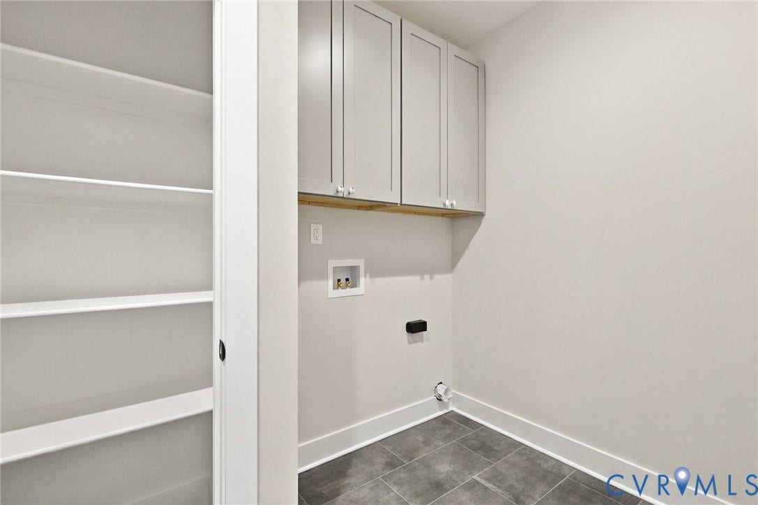 14010 Summercliff Trail, Chesterfield, VA 23832 Laundry Room is Conveniently Located Down the Hall from the Primary & Includes a Closet w/Wood Shelving & Cabinets Above the Washer/Dryer Location.