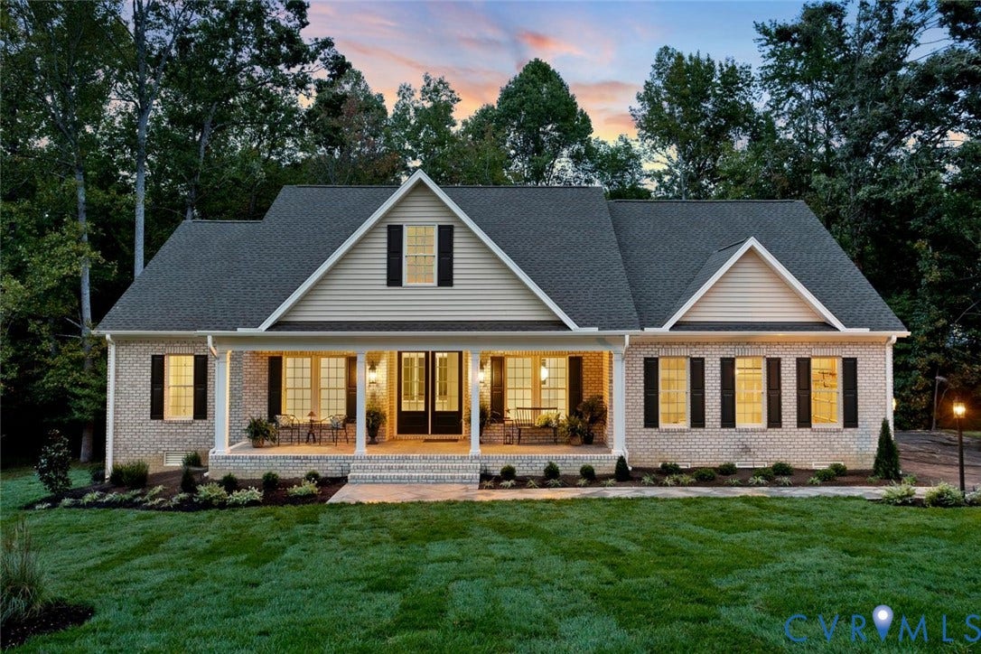14010 Summercliff Trail, Chesterfield, VA 23832 Brick exterior with a covered porch, gabled rooflines, dark shutters, and a manicured sod lawn