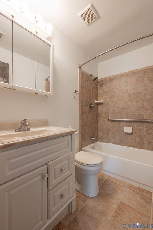 White vanity with a neutral-toned countertop and integrated sink