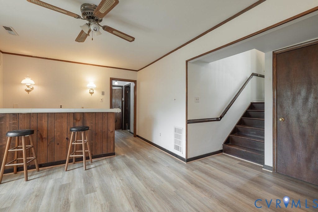 Recessed built-in bar with wood paneling and a light-toned countertop