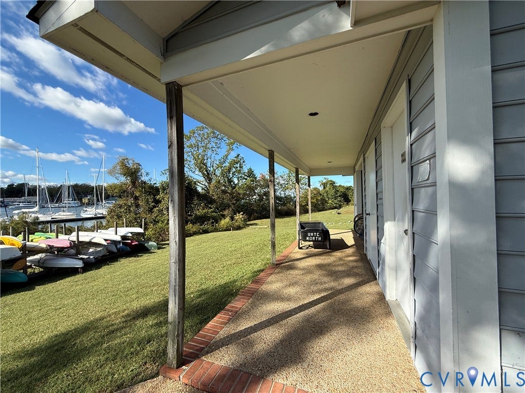 #30 Molly's Way, Urbanna, VA 23175 Covered porch with exposed aggregate concrete flooring and brick edging