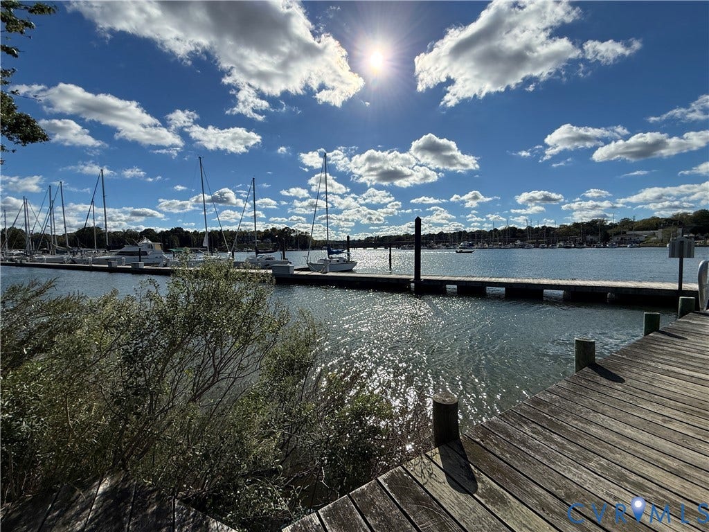 #30 Molly's Way, Urbanna, VA 23175 Expansive waterfront setting with a private wooden dock, offering direct access to the marina
