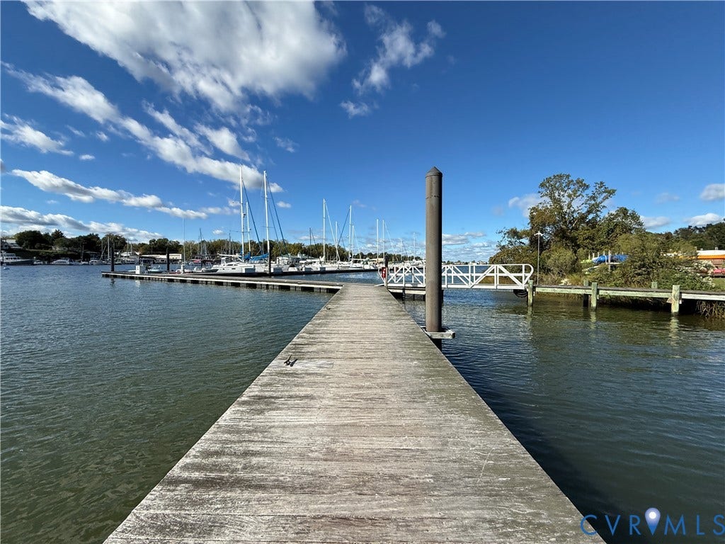 #30 Molly's Way, Urbanna, VA 23175 Dock access to open water, marina with multiple boat slips, and a pedestrian bridge