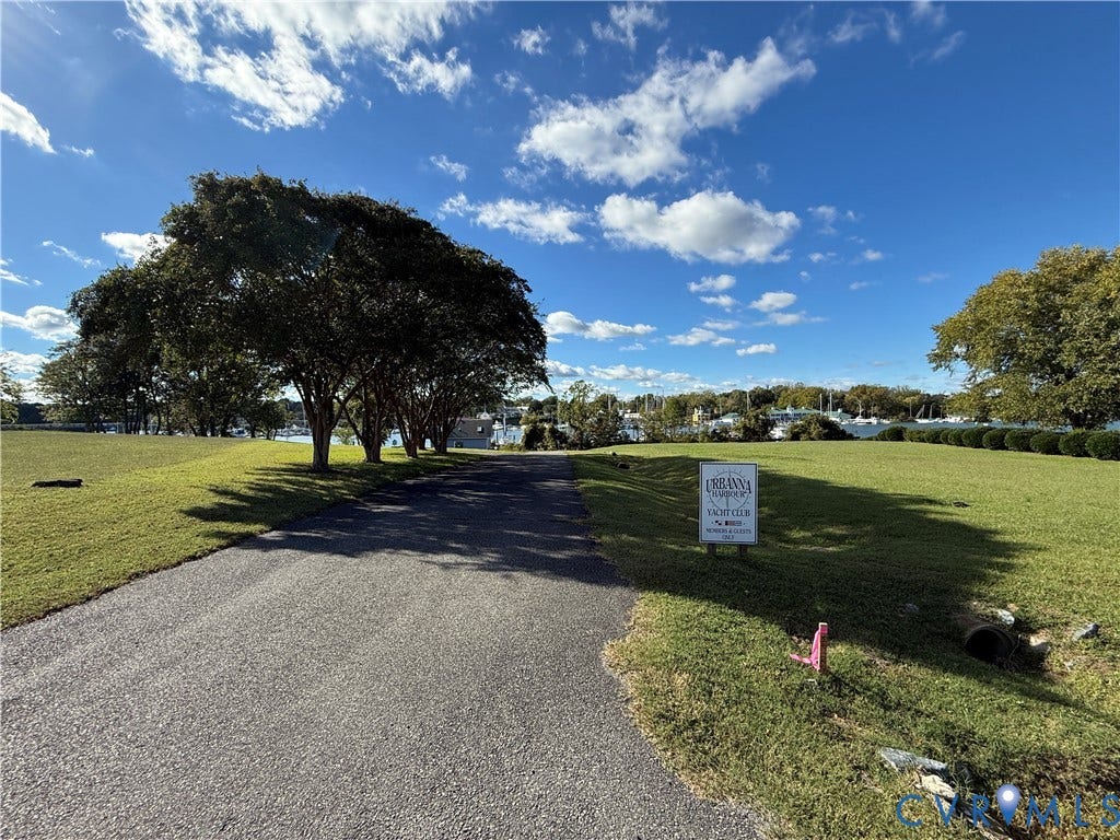#30 Molly's Way, Urbanna, VA 23175 Expansive grassy lot featuring mature trees and a paved drive