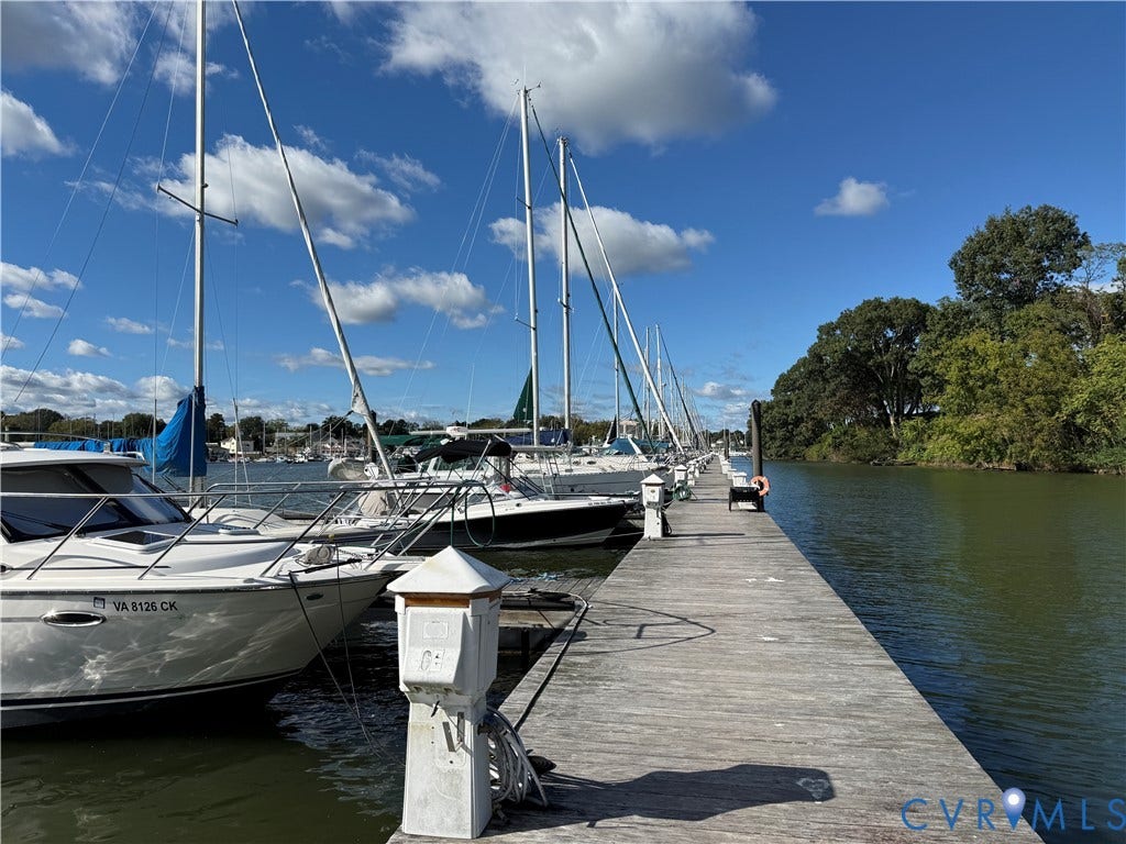 #30 Molly's Way, Urbanna, VA 23175 Waterfront dock with multiple boat slips, surrounded by mature trees