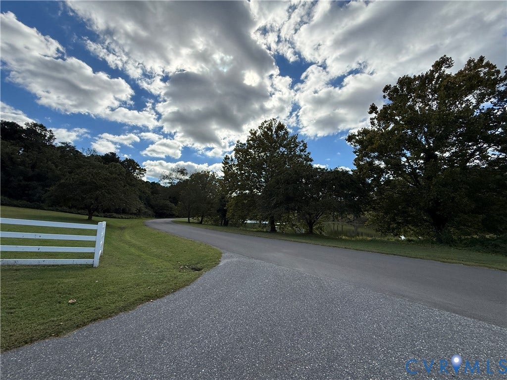 #30 Molly's Way, Urbanna, VA 23175 Paved roadway with a white split-rail fence and green lawn