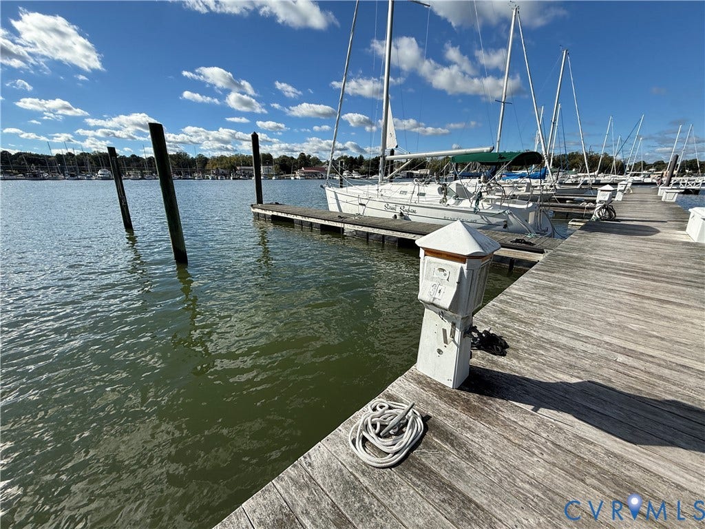 #30 Molly's Way, Urbanna, VA 23175 Waterfront setting with a wooden dock and multiple boat slips
