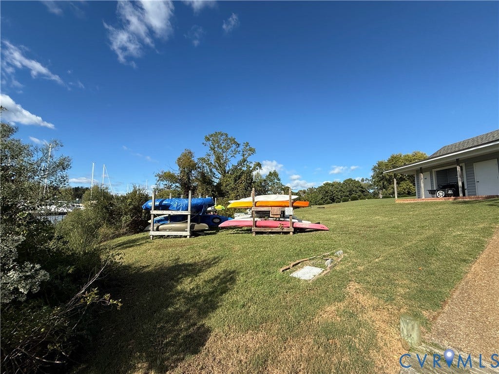#30 Molly's Way, Urbanna, VA 23175 Manicured lawn with a detached structure featuring a covered porch