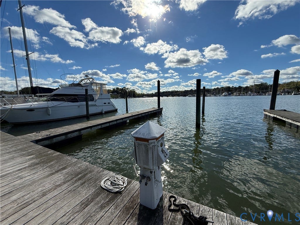 #30 Molly's Way, Urbanna, VA 23175 Expansive waterfront access featuring a private wooden dock, boat slip, and direct water frontage