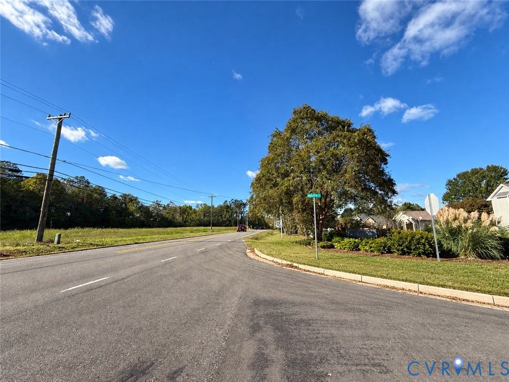 #30 Molly's Way, Urbanna, VA 23175 Expansive undeveloped lot with natural ground cover, mature tree, and paved road frontage
