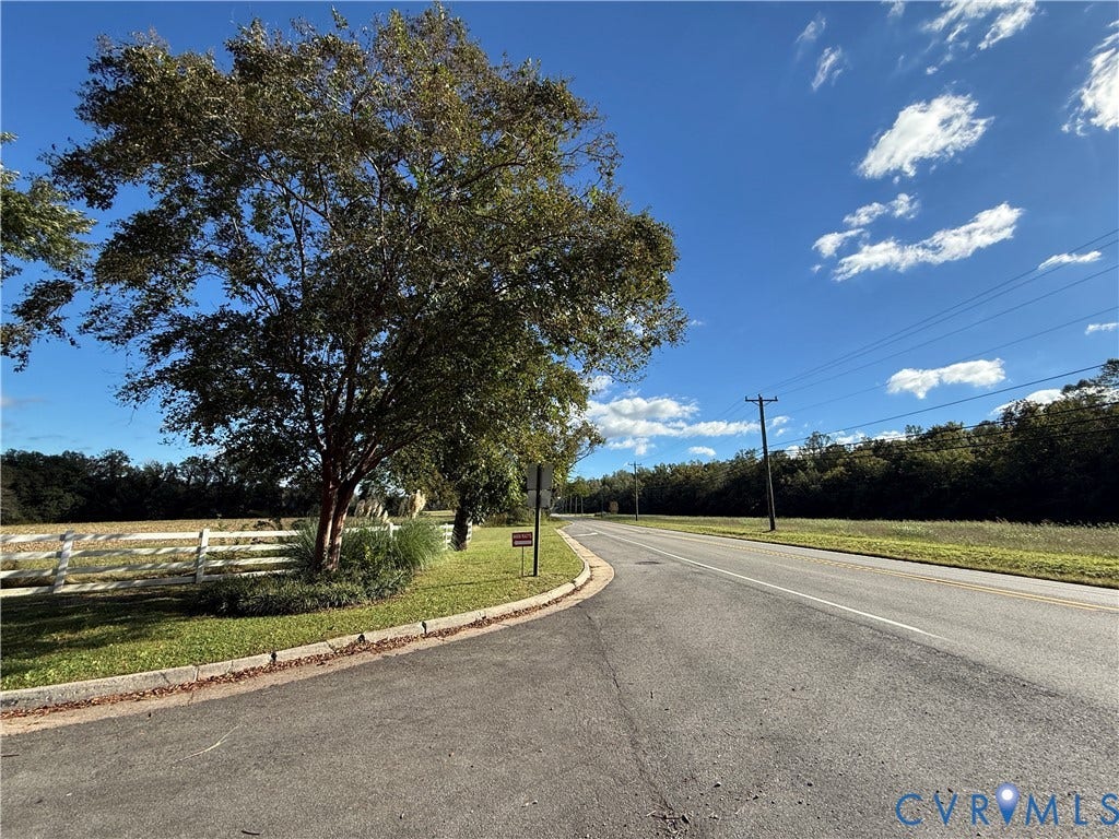 #30 Molly's Way, Urbanna, VA 23175 Road frontage with a white perimeter fence and mature trees
