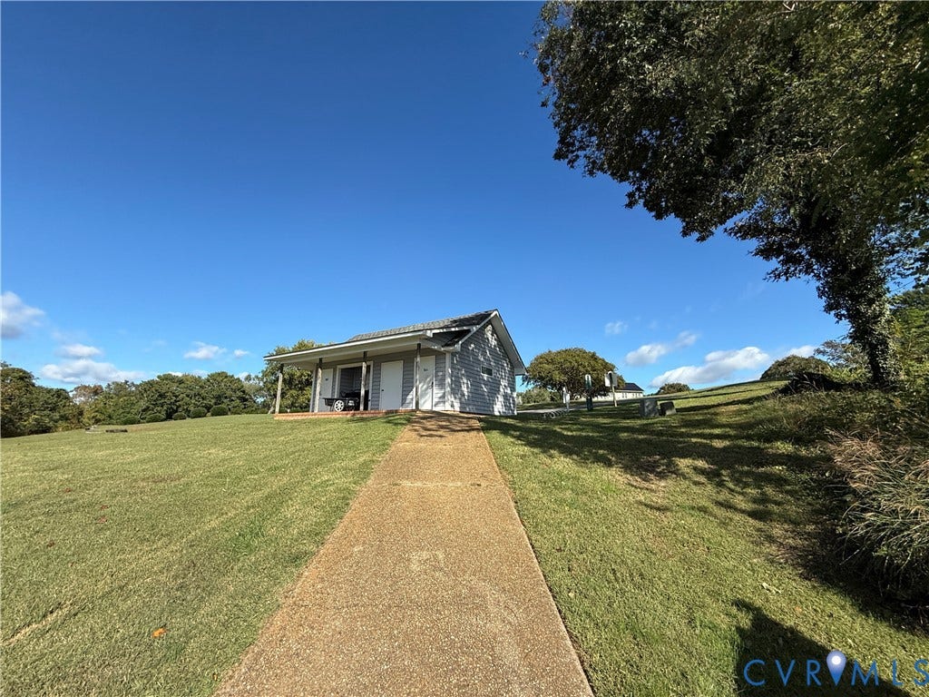 #30 Molly's Way, Urbanna, VA 23175 White siding home with a covered porch and concrete pathway