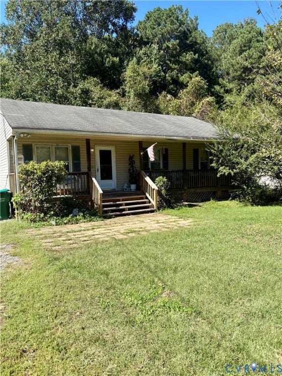 Ranch-style residence featuring a covered front porch with wood railings and steps, horizontal siding, and a gabled roof