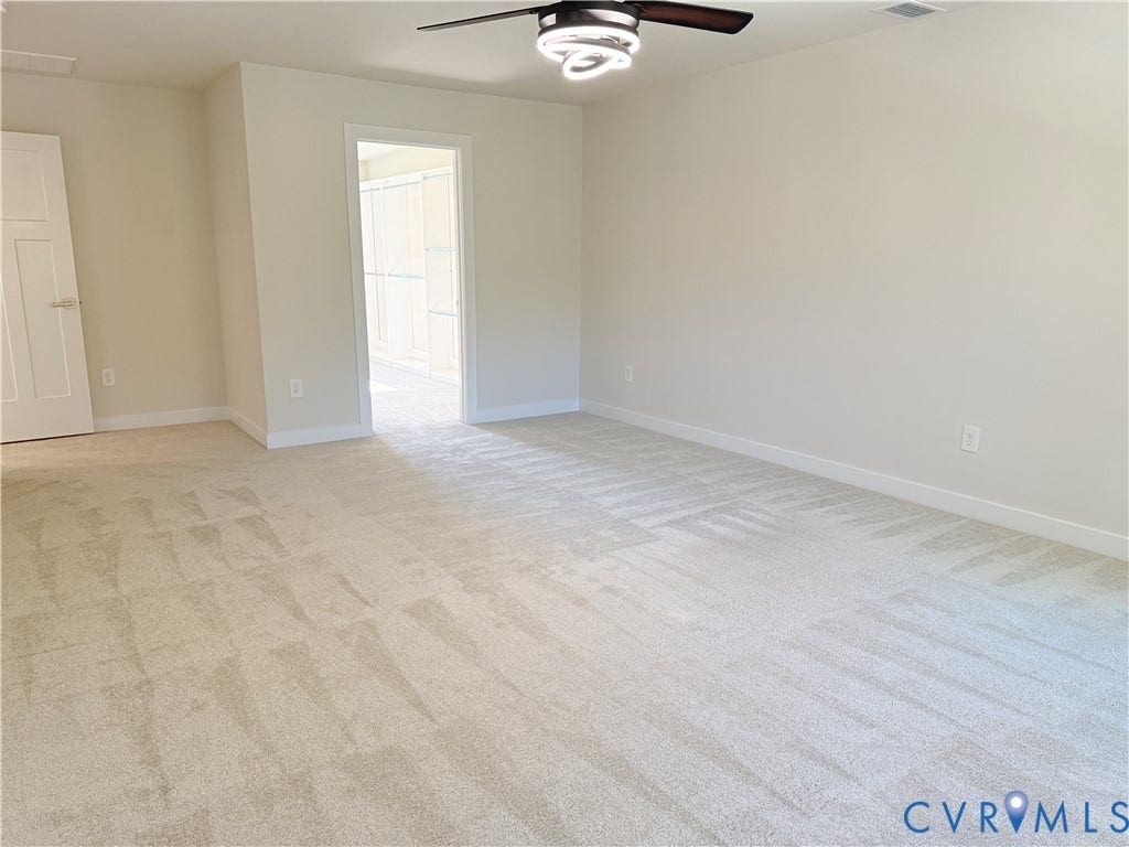 14225 Botsford Avenue, Wellspring, Chester, VA 23831 Neutral-toned carpeted flooring, multi-panel interior door, and modern ceiling fan with integrated circular LED lighting fixture