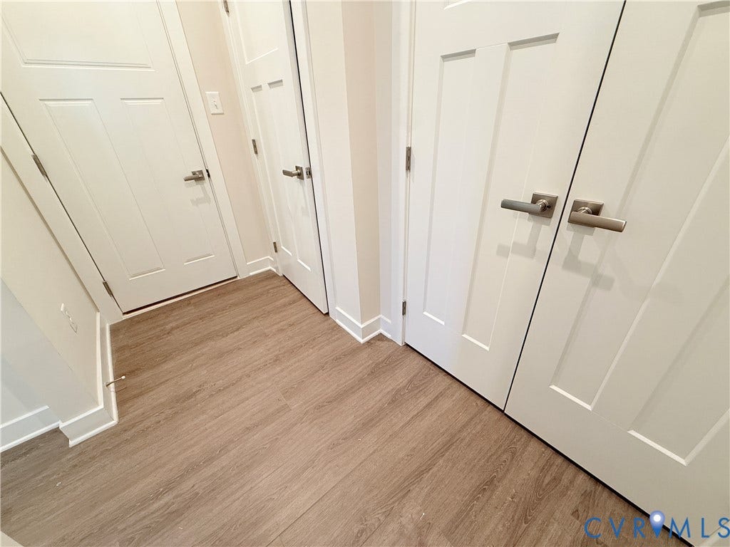 14225 Botsford Avenue, Wellspring, Chester, VA 23831 Wood-finish flooring, white four-panel interior doors, and satin nickel lever hardware