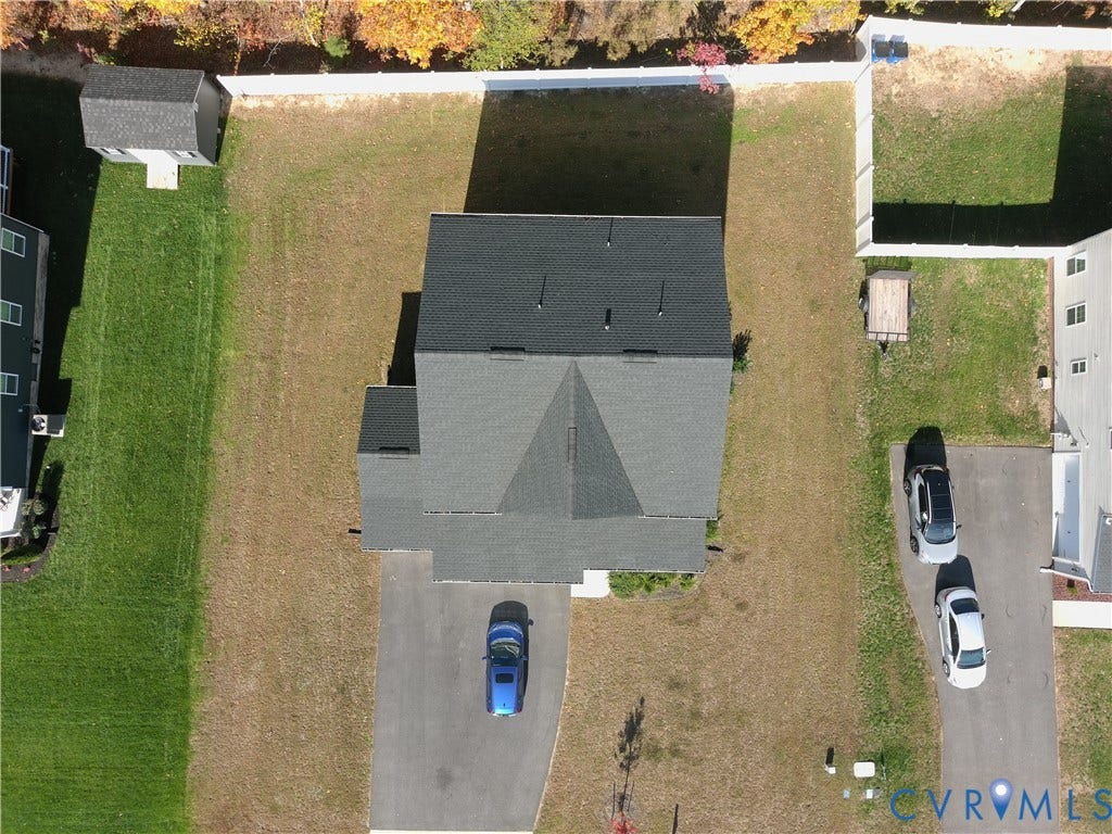 14225 Botsford Avenue, Wellspring, Chester, VA 23831 Aerial view of property featuring a detached storage shed, perimeter privacy fencing, and an asphalt driveway