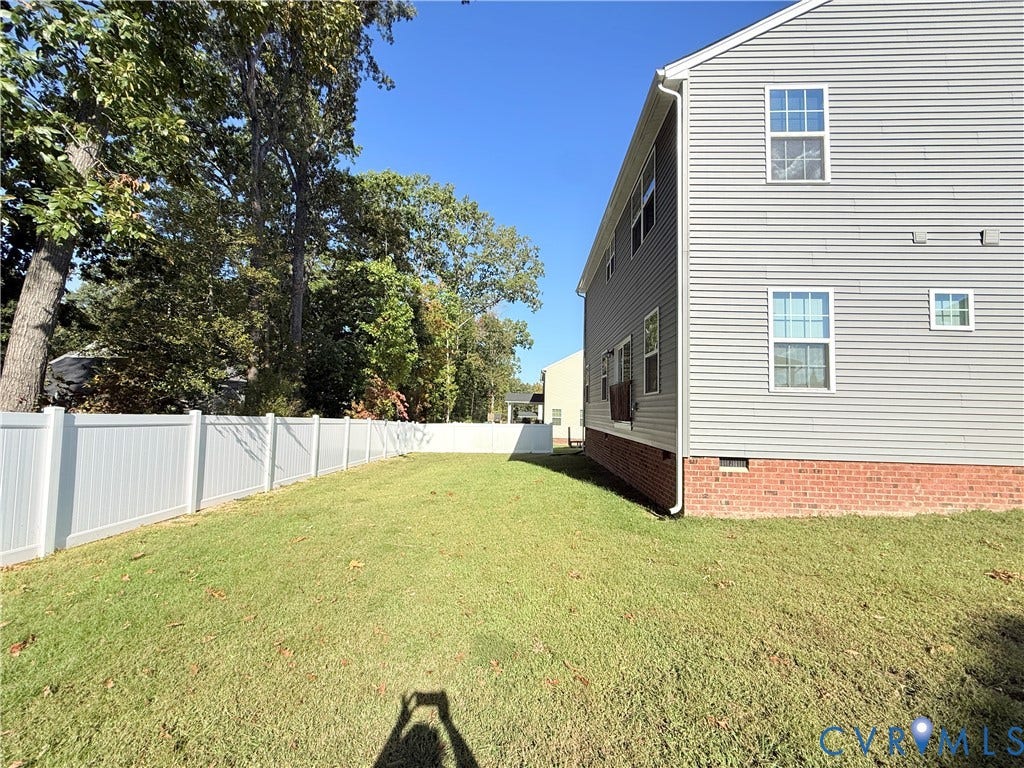 14225 Botsford Avenue, Wellspring, Chester, VA 23831 Expansive green lawn with a white privacy fence