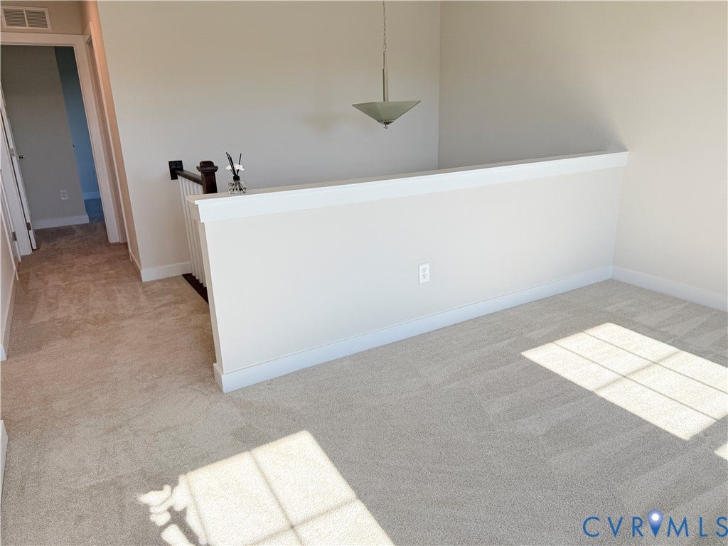 14225 Botsford Avenue, Wellspring, Chester, VA 23831 Neutral-toned carpeting, half-wall partition with a white cap, pendant lighting fixture, and a wooden handrail with balusters