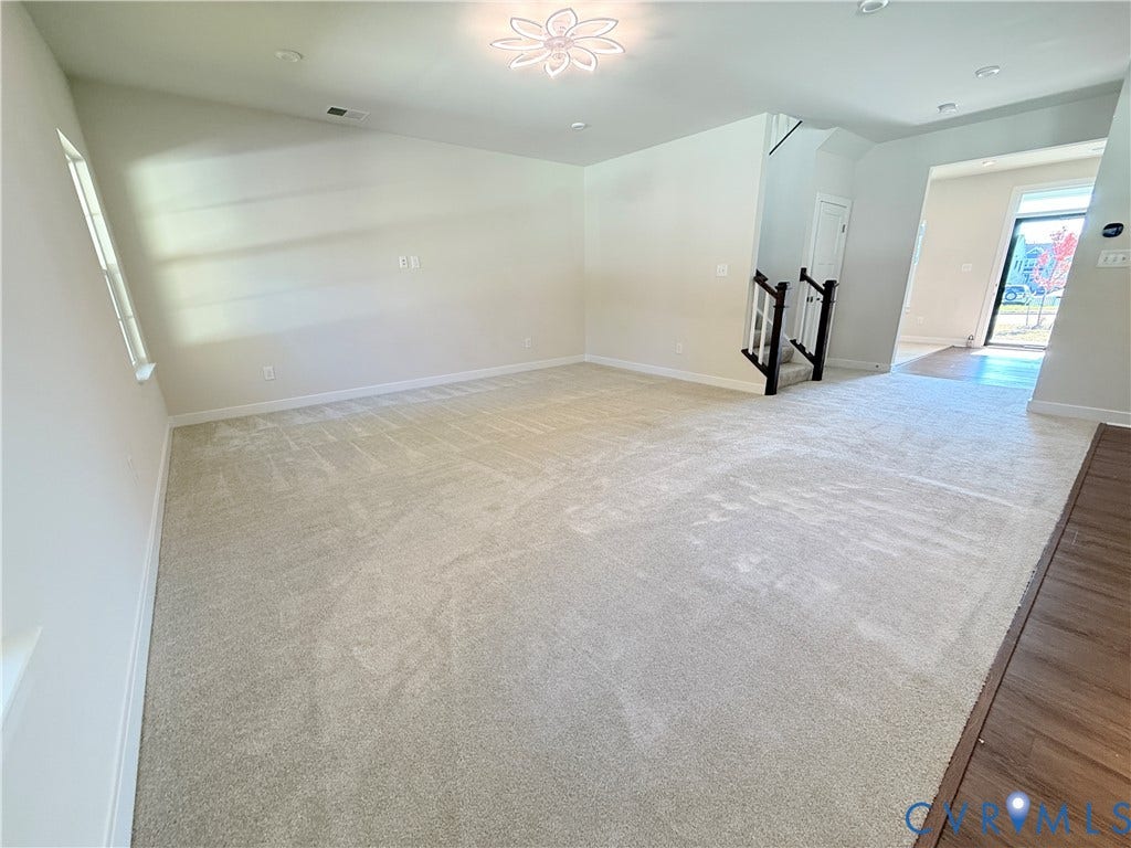 14225 Botsford Avenue, Wellspring, Chester, VA 23831 Interior space featuring neutral wall-to-wall carpeting, wood-finish flooring accents, recessed ceiling lighting, a decorative flush-mount light fixture, and a staircase with a dark-finish wooden railing