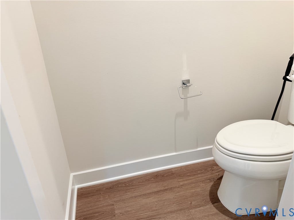 14225 Botsford Avenue, Wellspring, Chester, VA 23831 White porcelain toilet, wood-finish flooring, and chrome hardware