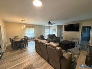 Open concept living space with wood-finish flooring
