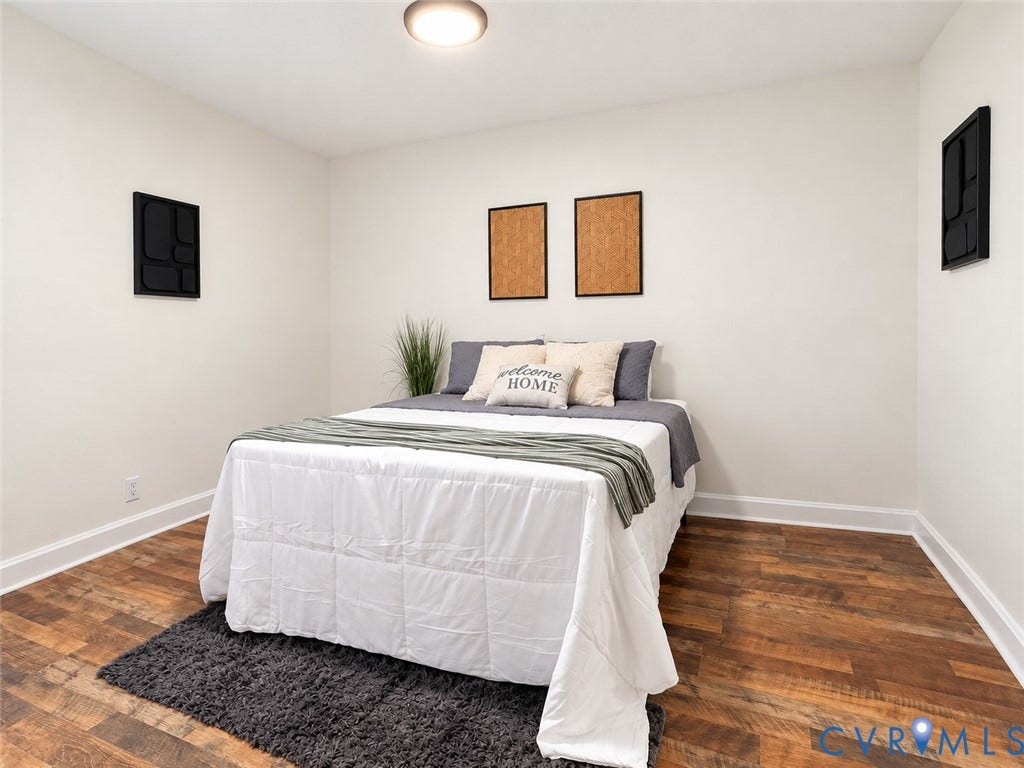 Recessed ceiling light fixture, wood-finish flooring, and white wall paint