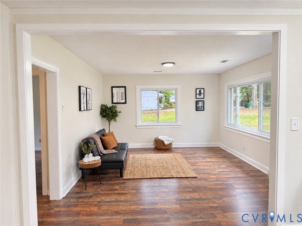 Wood-finish flooring, neutral wall tones, white trim, and recessed lighting