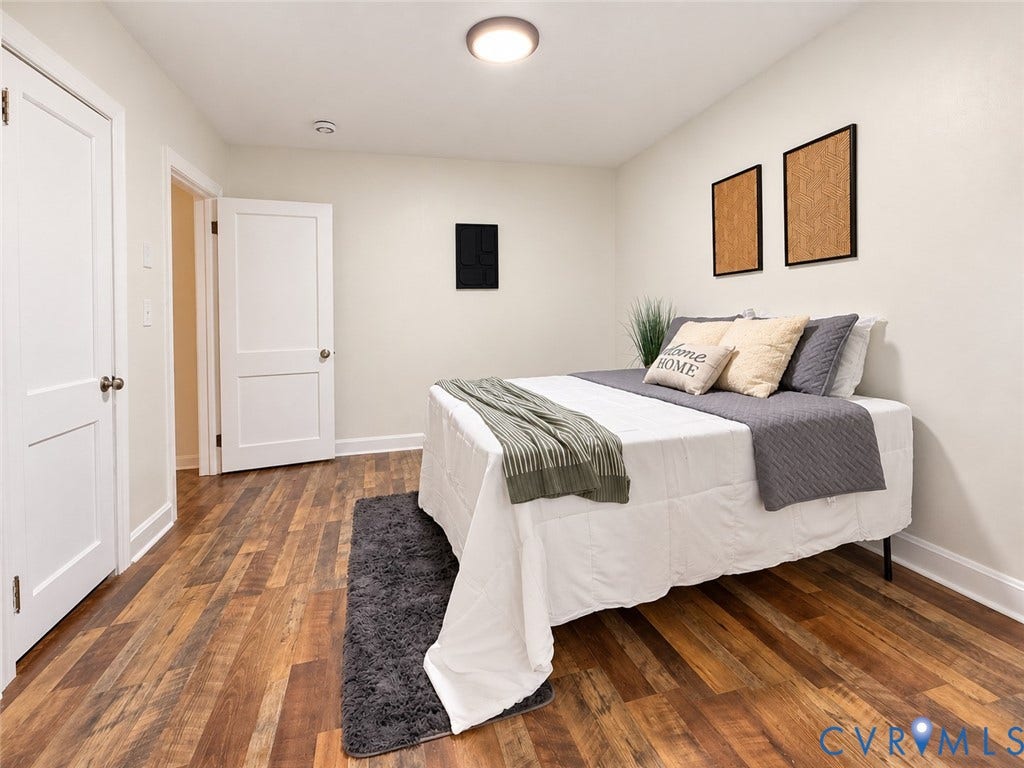 Wood-finish flooring throughout, bright white walls, and a recessed ceiling light fixture