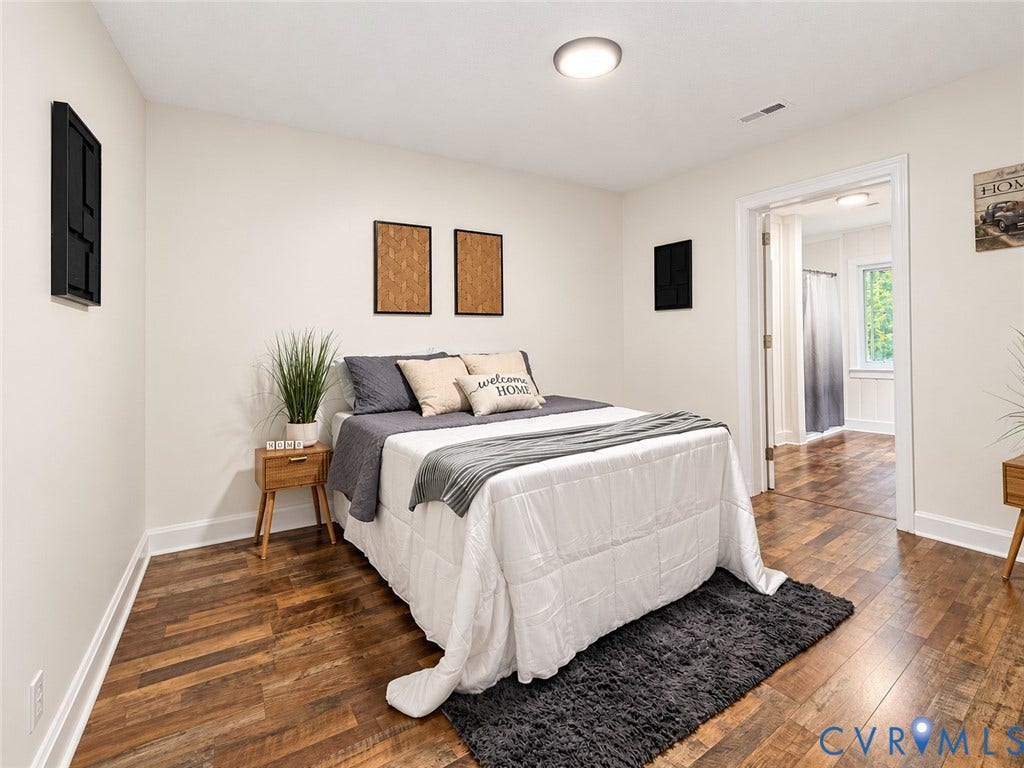Wood-finish flooring, white walls, and a recessed ceiling light create a bright atmosphere