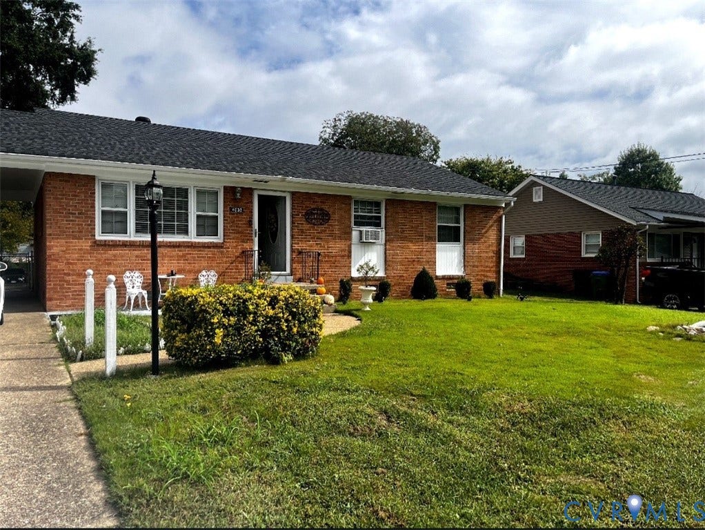 4030 Old Warwick Road, Richmond, VA 23234 Brick exterior with a dark shingle roof, established front yard, and paved walkway
