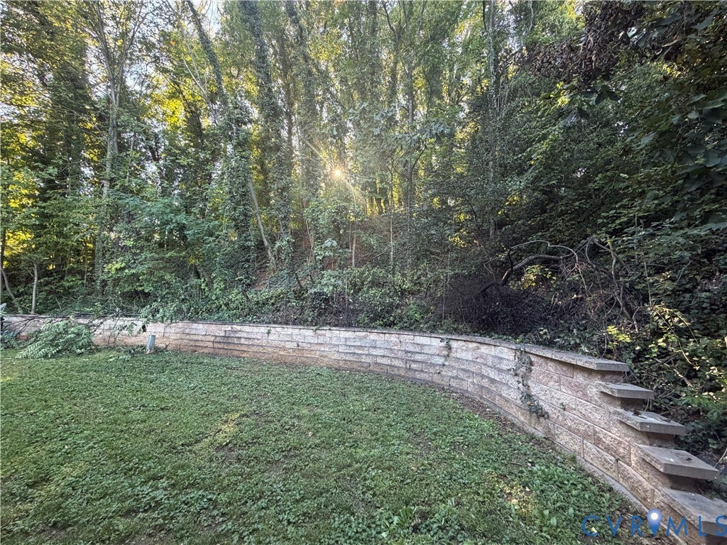 Terraced landscaping with a stone retaining wall and integrated steps
